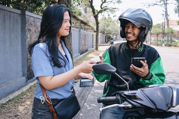Customer paying a delivery rider on the street